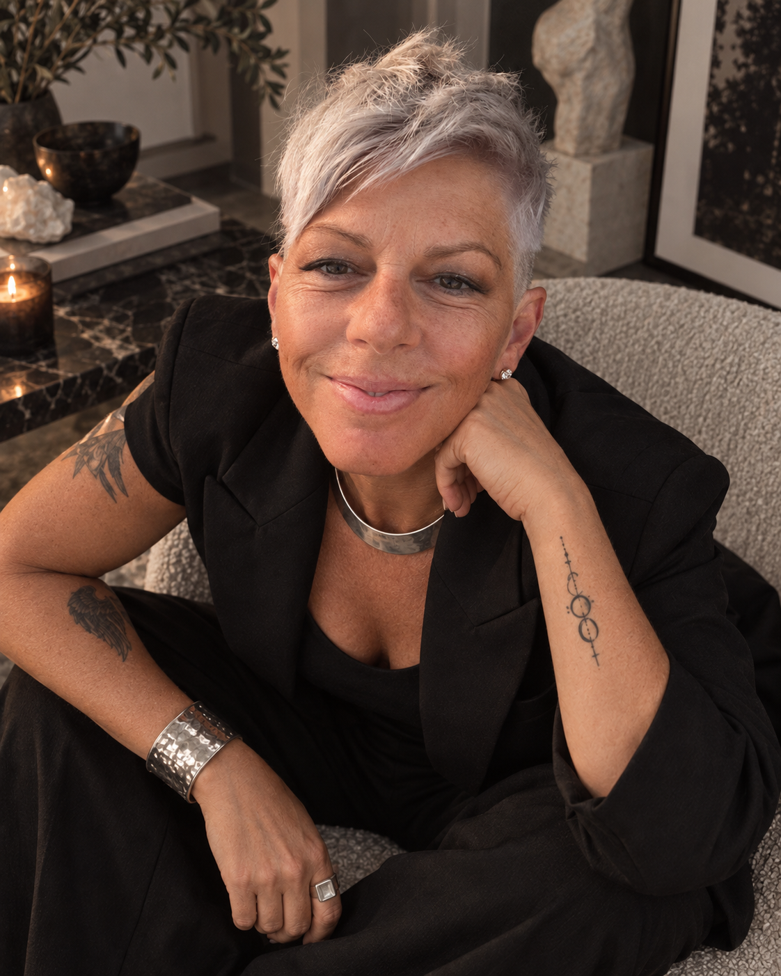 PHLUX smiling in a black suit with silver jewelry